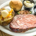 picture featyuring Dyer's prime rib special with sides including a loaded baked potato